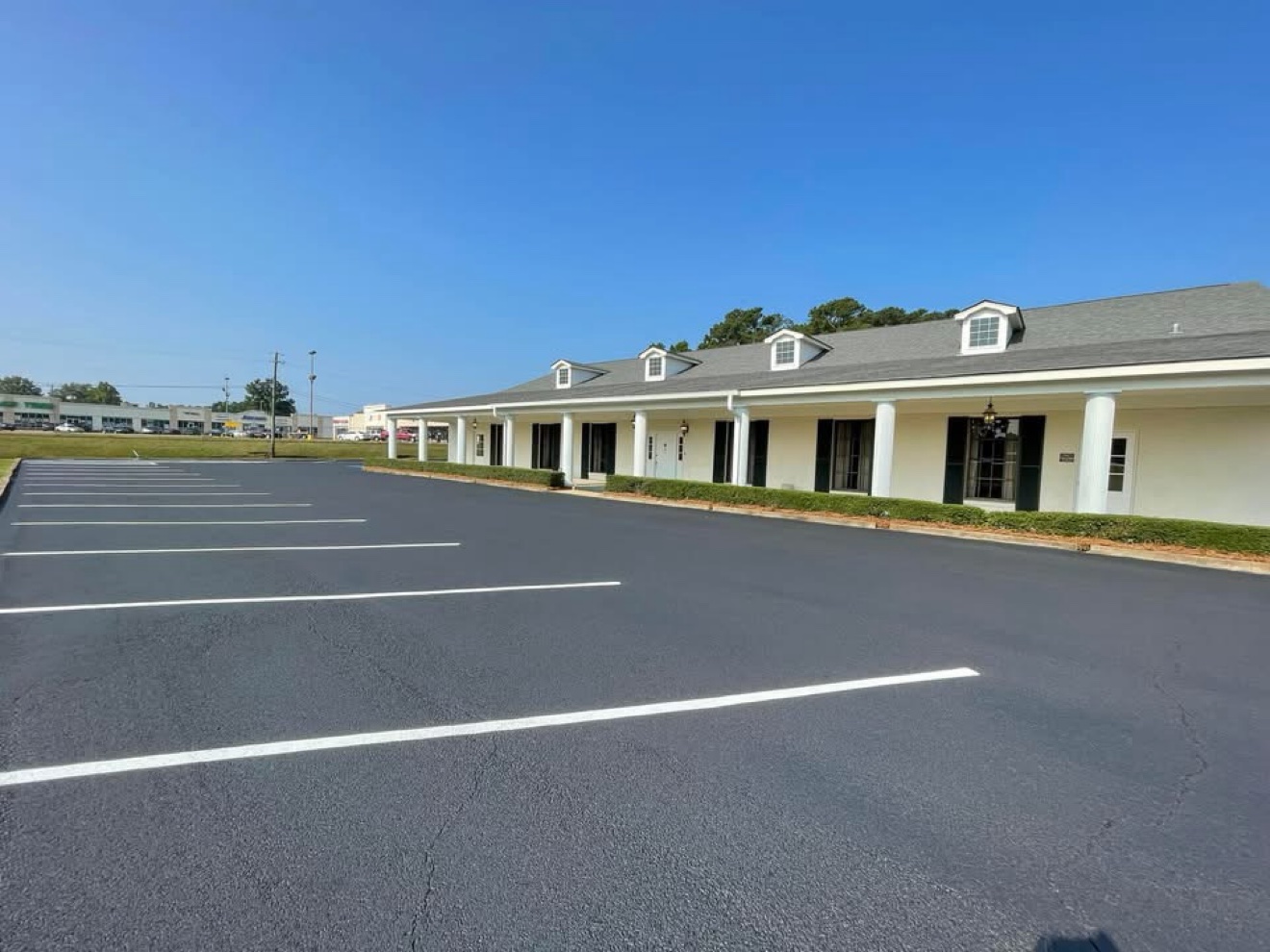 Sealcoated commercial parking lot with fresh stall lines